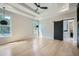 Spacious main bedroom with tray ceilings, ceiling fan, and a barn door leading to the ensuite bathroom at 2740 Drew Valley Ne Rd, Brookhaven, GA 30319