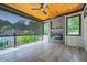 Relaxing outdoor patio with sunshade, ceiling fan, fireplace, and wooden ceiling at 2740 Drew Valley Ne Rd, Brookhaven, GA 30319