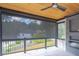 Covered porch with wood ceiling, ceiling fan, roll down shades and fireplace at 2740 Drew Valley Ne Rd, Brookhaven, GA 30319