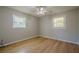 Cozy bedroom with hardwood floors, ceiling fan, and natural light from two windows at 3710 A B Lynn Dr, Powder Springs, GA 30127