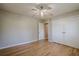 Bedroom featuring hardwood floors, ceiling fan, closet, and a bright window at 3710 A B Lynn Dr, Powder Springs, GA 30127