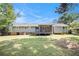 View of the backyard with a covered porch attached to a single-story home under a blue sky at 7248 Banks Mill Rd, Douglasville, GA 30135