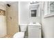 A bathroom with a tiled shower, a white vanity, and neutral wall color at 7248 Banks Mill Rd, Douglasville, GA 30135