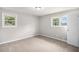 Bright bedroom with soft carpet, two windows, neutral paint, and ample lighting at 7248 Banks Mill Rd, Douglasville, GA 30135