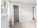 Neutral bedroom features carpet flooring, natural light from window, and storage closet at 7248 Banks Mill Rd, Douglasville, GA 30135