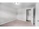 A bright bedroom with carpeted floors and a door leading to another room at 7248 Banks Mill Rd, Douglasville, GA 30135