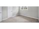 Bedroom with a neutral wall, carpeted floor, closet, and window view at 7248 Banks Mill Rd, Douglasville, GA 30135