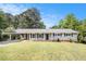 Charming single-story home featuring a covered carport, nicely manicured front lawn, and classic curb appeal at 7248 Banks Mill Rd, Douglasville, GA 30135