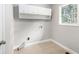 A laundry room with overhead cabinets and tile floors at 7248 Banks Mill Rd, Douglasville, GA 30135