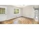 Light-filled living room featuring wood floors, white trim and door, and large window at 7248 Banks Mill Rd, Douglasville, GA 30135