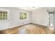 Well-lit living room featuring new hardwood floors, a back door, and a large window with natural light at 7248 Banks Mill Rd, Douglasville, GA 30135