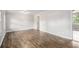 Spacious living room with hardwood floors, light gray walls, and an open doorway to other rooms at 7248 Banks Mill Rd, Douglasville, GA 30135