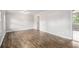 Bright living room featuring wood floors, neutral paint, and abundant natural light at 7248 Banks Mill Rd, Douglasville, GA 30135