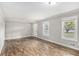 Spacious living room featuring laminate flooring, neutral paint, and natural light at 7248 Banks Mill Rd, Douglasville, GA 30135