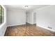 Bright living room featuring wood floors, neutral paint, and ample natural light at 7248 Banks Mill Rd, Douglasville, GA 30135