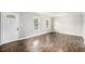 Inviting living room features wood floors, two windows, and decorative front door at 7248 Banks Mill Rd, Douglasville, GA 30135