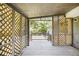 A screened patio with wood lattice overlooks the backyard at 7248 Banks Mill Rd, Douglasville, GA 30135