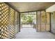 A screened porch featuring wooden lattice walls and a view of the backyard at 7248 Banks Mill Rd, Douglasville, GA 30135