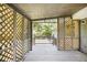 This covered porch is enhanced with privacy latticework and a serene view, perfect for outdoor relaxation at 7248 Banks Mill Rd, Douglasville, GA 30135
