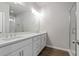 Bathroom featuring dual sinks, a large mirror, bright lighting, and a walk-in shower at 18 Black Gum Ln # 53, Auburn, GA 30011