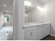 Open view of the bathroom featuring dual sinks, bright lighting, and walk-in shower at 18 Black Gum Ln # 53, Auburn, GA 30011