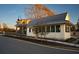 Charming cottage-style home features board and batten siding, metal roof, and a welcoming peach colored front door at 18 Black Gum Ln # 53, Auburn, GA 30011