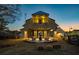 Modern farmhouse-style pool house at dusk featuring an exposed beam structure and covered patio with outdoor seating at 18 Black Gum Ln # 53, Auburn, GA 30011