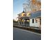 Charming cottage-style home featuring board and batten siding, metal roof, and a welcoming peach colored front door at 18 Black Gum Ln # 53, Auburn, GA 30011