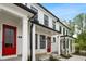 Attractive townhome showcasing a white facade, contrasting black trim, and a vibrant red front door at 18 Black Gum Ln # 53, Auburn, GA 30011