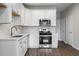 Modern kitchen with white cabinets, stainless steel appliances and hard surface flooring at 18 Black Gum Ln # 53, Auburn, GA 30011