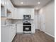 Modern kitchen with white cabinets, stainless steel appliances and a contemporary backsplash at 18 Black Gum Ln # 53, Auburn, GA 30011