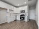 Stylish, well-equipped kitchen with white cabinets, stainless steel appliances and hard surface flooring at 18 Black Gum Ln # 53, Auburn, GA 30011