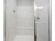 Walk-in shower with a built-in shower bench, tiled walls, and a sliding glass door at 18 Black Gum Ln # 53, Auburn, GA 30011