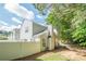 Backyard featuring a white vinyl fence, grassy lawn, and mature shade trees at 606 Windcroft Nw Cir, Acworth, GA 30101