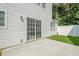 Backyard view with concrete patio, white fence, grassy area, and sliding glass door at 606 Windcroft Nw Cir, Acworth, GA 30101