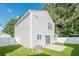 Spacious backyard featuring green lawn, concrete patio, white fence, and home's exterior at 606 Windcroft Nw Cir, Acworth, GA 30101