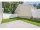 A view of the backyard, showing the patio, grassy yard, and white fence at 606 Windcroft Nw Cir, Acworth, GA 30101