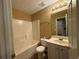 Well-lit bathroom featuring a vanity with storage, a toilet, and a bathtub with a shower at 606 Windcroft Nw Cir, Acworth, GA 30101