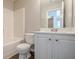 Clean bathroom with white vanity, toilet, and shower-tub combination at 606 Windcroft Nw Cir, Acworth, GA 30101