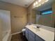 Bright bathroom with a large mirror, white vanity, and a bathtub with tiled walls, offering a fresh feel at 606 Windcroft Nw Cir, Acworth, GA 30101