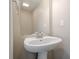 Bathroom featuring a pedestal sink, mirror, and neutral color scheme at 606 Windcroft Nw Cir, Acworth, GA 30101