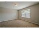 Bright carpeted bedroom featuring a window, neutral paint, and textured ceilings at 606 Windcroft Nw Cir, Acworth, GA 30101
