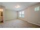 Spacious carpeted bedroom with ensuite bathroom featuring neutral walls and a window at 606 Windcroft Nw Cir, Acworth, GA 30101