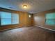 Neutral bedroom with carpet flooring, ample natural light from large windows, and plenty of space at 606 Windcroft Nw Cir, Acworth, GA 30101