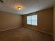 Inviting bedroom with plush carpet flooring, a large window, and neutral walls, perfect for relaxation at 606 Windcroft Nw Cir, Acworth, GA 30101