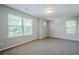 Bright bedroom featuring neutral tones, plush carpeting, and double windows at 606 Windcroft Nw Cir, Acworth, GA 30101