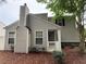 Exterior side view of the home showcasing vinyl siding, well-maintained landscaping and cozy front porch at 606 Windcroft Nw Cir, Acworth, GA 30101