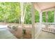 View of the front porch showing white pillars and a nice view of the front yard and landscaping at 606 Windcroft Nw Cir, Acworth, GA 30101