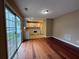 Open-concept space seamlessly blends dining and kitchen areas, featuring hardwood floors and white appliances at 606 Windcroft Nw Cir, Acworth, GA 30101