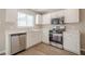Close-up of modern kitchen showcasing white cabinets, stainless steel appliances, and bright lighting at 606 Windcroft Nw Cir, Acworth, GA 30101